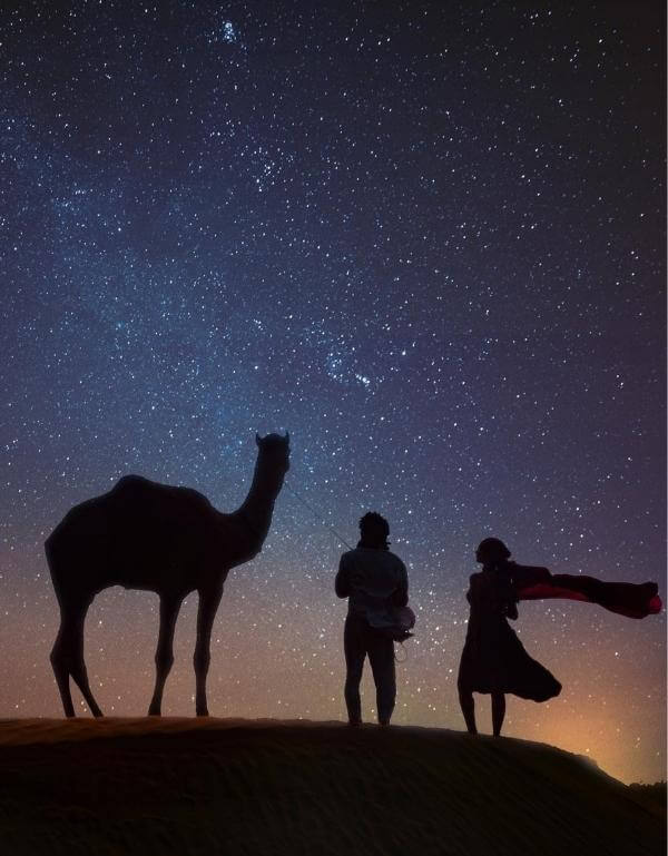 Couple stargazing in jaisalmer desert
