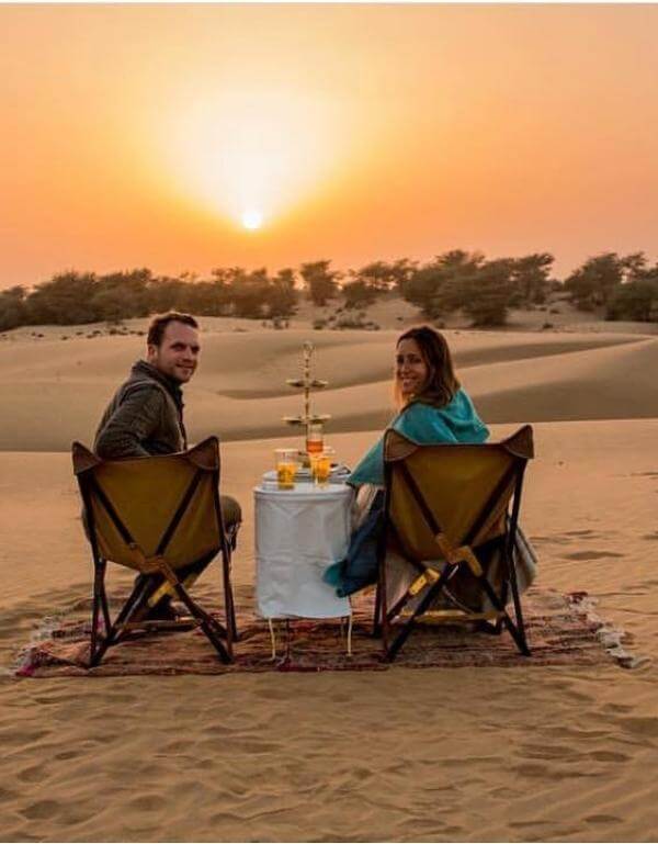 Couple enjoying candlelight dinner in sam sand dunes